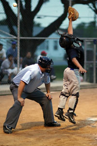 catcher reaching for a pitch