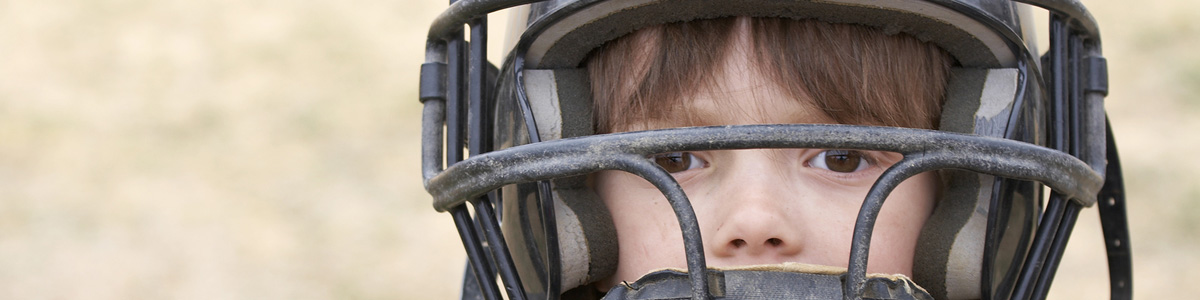 Young baseball player with catchers gear on